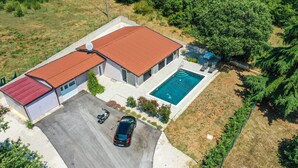 A residential property with a swimming pool, a garage, and a covered carport. - Gorgeous home in Nova Vas (Nova Vas)