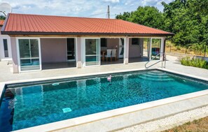 A modern house with a swimming pool, large glass doors, and a red-tiled roof. - Gorgeous home in Nova Vas (Nova Vas)
