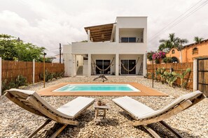 A modern two-story house with a swimming pool, a wooden deck, and a fenced garden with cacti. - Bahía Sirenas (Puerto Escondido)