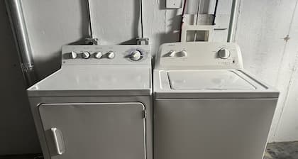 Cozy 2-bedroom house in Minot, with a comfortable living room, AC, and WiFi.