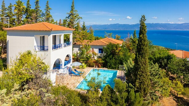 A villa with a swimming pool, a terrace, and a view of the sea. - Villa Cleo With 3 Bedrooms and 2 Bathrooms (Messini)