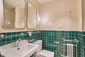 Ein Badezimmer mit Waschbecken, Toilette und Spiegel.