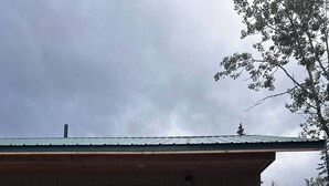 A small cabin with a porch, a door, and a window. - Adventure Stay Unit 2 (Palmer)