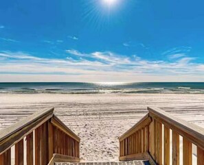 A wooden boardwalk leading to a beach with ocean waves in the background. - Islander E 7011, Stunning oceanfront condo (Fort Walton Beach)