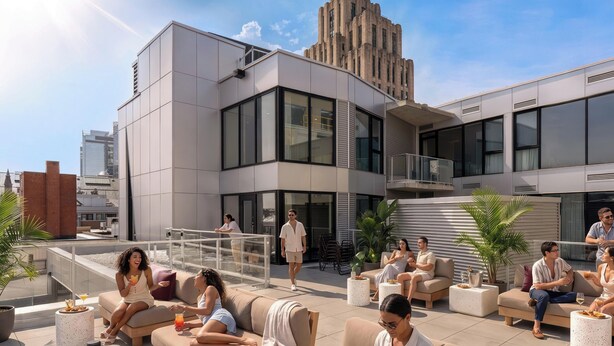 A rooftop lounge with outdoor seating, a modern building in the background, and a clear sky. - Loft | Furnished Apartment Old Montreal, Quiet Courtyard, King Bed (Montréal)