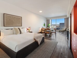 A hotel room with a large bed, a desk with chairs, a view of the city, and a balcony. - Loft | Quiet Apartment Old Montreal, Courtyard, Full Kitchen (Montréal)