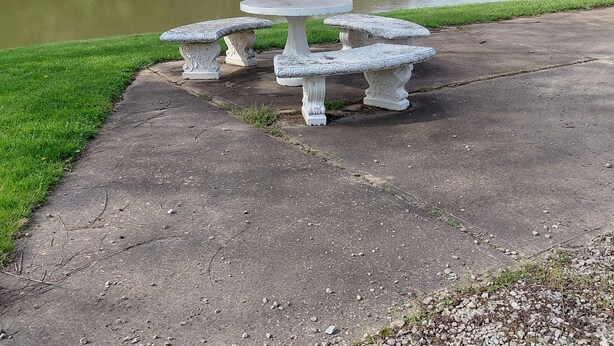 A concrete table and benches by a lake. - Tranquility surrounds this house. View includes Three Lakes &  Quiet wilderness. (Jeannette)