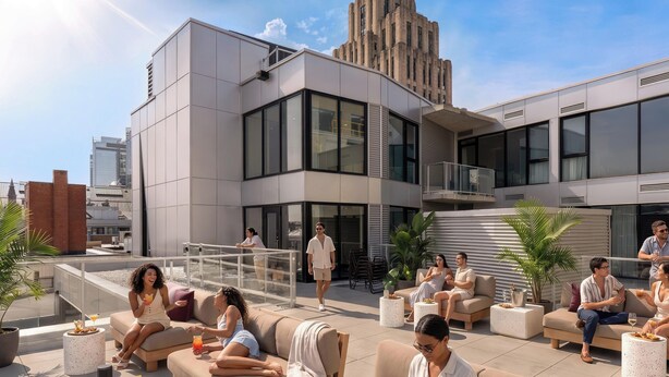 A rooftop lounge with outdoor seating, a modern building in the background, and a clear sky. - Loft with Balcony | Furnished Apartment Old Montreal, Accessible (Montréal)