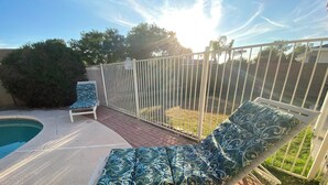 A poolside area with a lounge chair, a second lounge chair, and a small pool. - Mesa Nomad Mecca refreshing Diving Pool + splash pad & patio, Dog friendly! (Mesa)