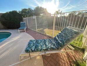 A poolside area with a lounge chair, a second lounge chair, and a small pool. - Mesa Nomad Mecca refreshing Diving Pool + splash pad & patio, Dog friendly! (Mesa)