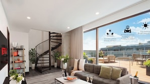 A modern living room with a staircase, a sofa, a coffee table, and a balcony with outdoor seating. - Penthouse | Luxury Residence Old Montreal, Private Terrace, Two Levels (Montréal)