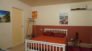 A bedroom with a bed, a wardrobe, a radiator, and wall art. - BlueHorizon180 is located in Ducos, the central town of Martinique. (Ducos)