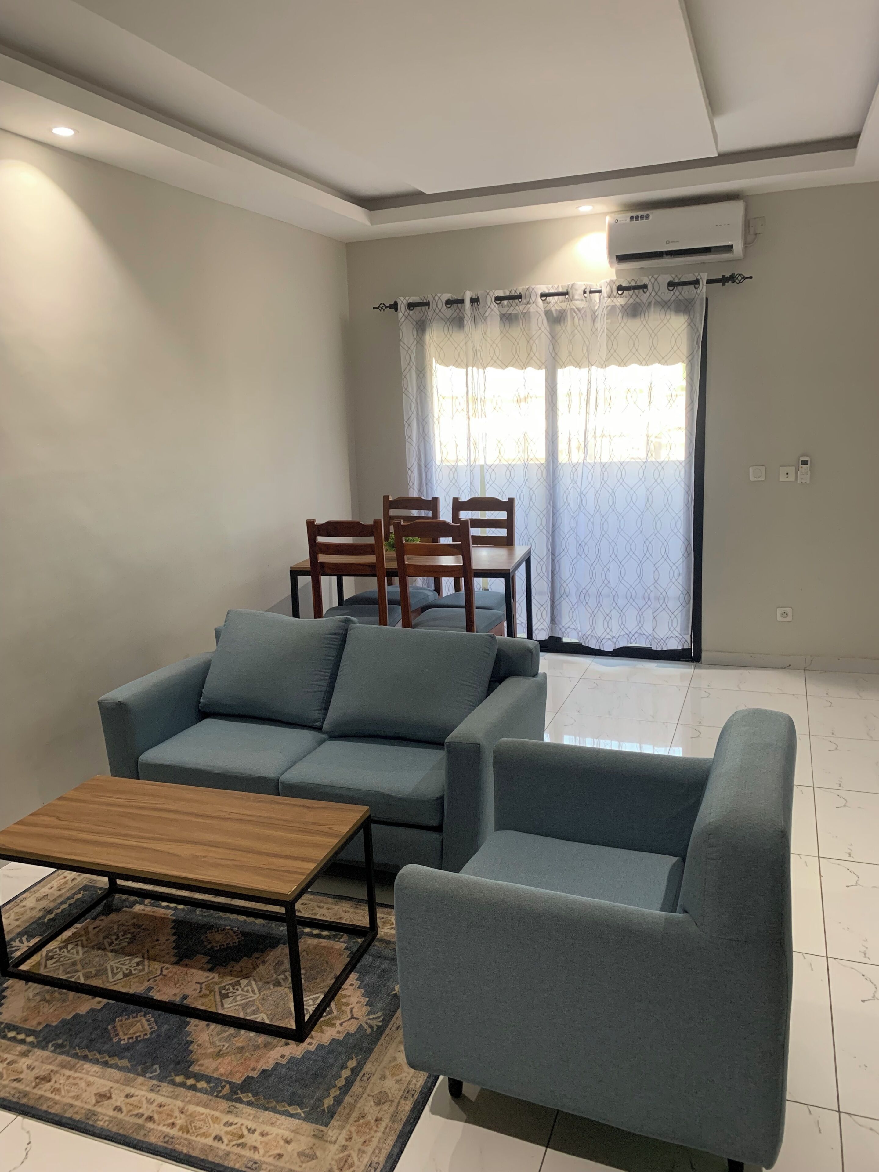 Deluxe Apartment, City View | Living area | 55-inch Smart TV with cable channels, printers
