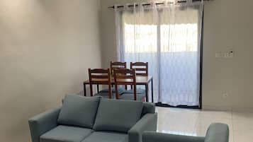 Deluxe Apartment, City View | Living area | 55-inch Smart TV with cable channels, printers