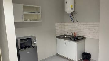 Deluxe Apartment, City View | Private kitchen | Microwave, cookware/dishes/utensils
