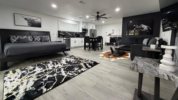 A modern interior with a bed, sofa, dining area, and kitchen. - Modern Luxury Studio Cozy Retreat (Zephyrhills)