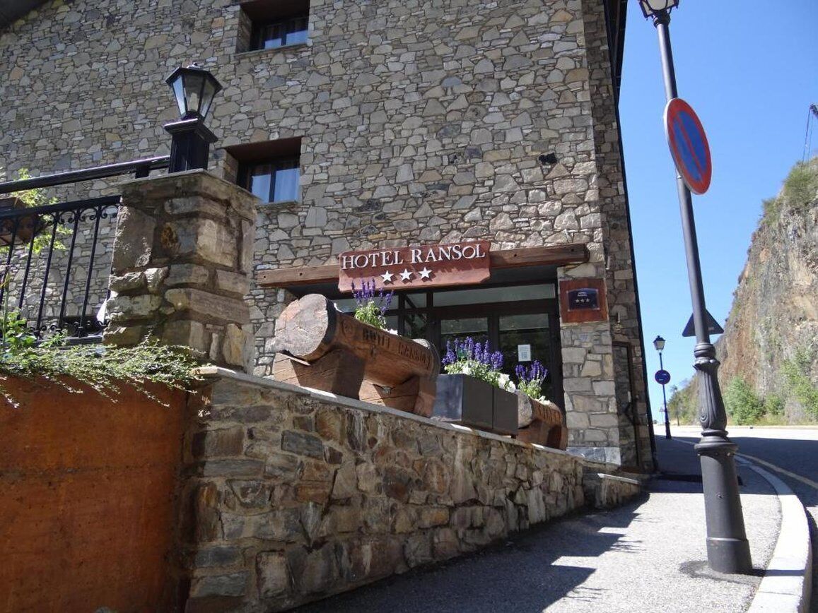 A stone building with a sign reading 'HOTEL RANSOL.'