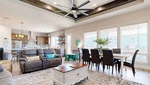 A spacious living area with a dining table, chairs, a sofa, and a ceiling fan. - PEL607 After Dune Delight, Private Heated Pool, Parking for 5 (Port Aransas)