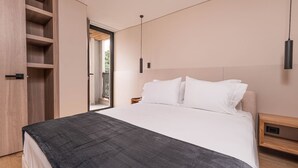 A modern bedroom with a bed, wooden wardrobe, and a view through an open door. - Jatisa 901 in Medell n (Medellín)