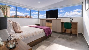 A modern bedroom with a bed, desk, and TV. - Oslo 701 in Medell n (Medellín)