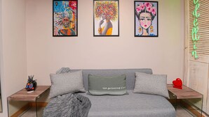 A modern living room with a grey sofa, two side tables, and three framed artworks on the wall. - Ayamonte 301a in Medell n (Medellín)