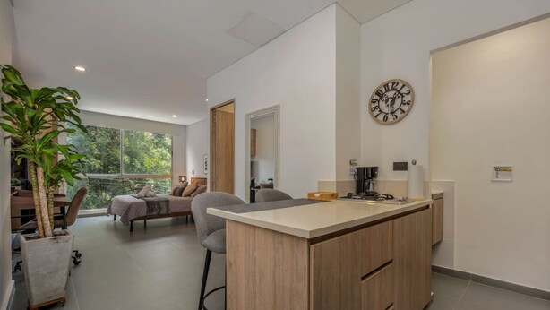 A modern kitchen with a central island, a dining area with a view, and a large window. - Oslo 603 B in Medell n (Medellín)