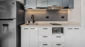 A modern kitchen with a built-in refrigerator, oven, and water dispenser. - Oslo 2101 in Medell n (Medellín)