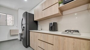 A modern kitchen with a built-in refrigerator, a coffee maker, and a stove. - Oslo 608 in Medell n (Medellín)