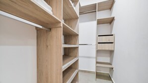 A closet with multiple wooden shelves and a metal ladder. - Oslo 608 in Medell n (Medellín)
