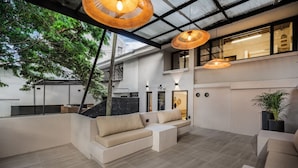 A modern interior with a sofa, pendant lights, and a staircase. - Luxurious 5BR House in Provenza Perfect for Groups (Medellín)