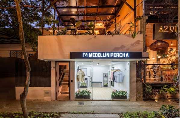 A storefront with a sign reading 'MEDELLIN PERCHA' and a visible entrance.