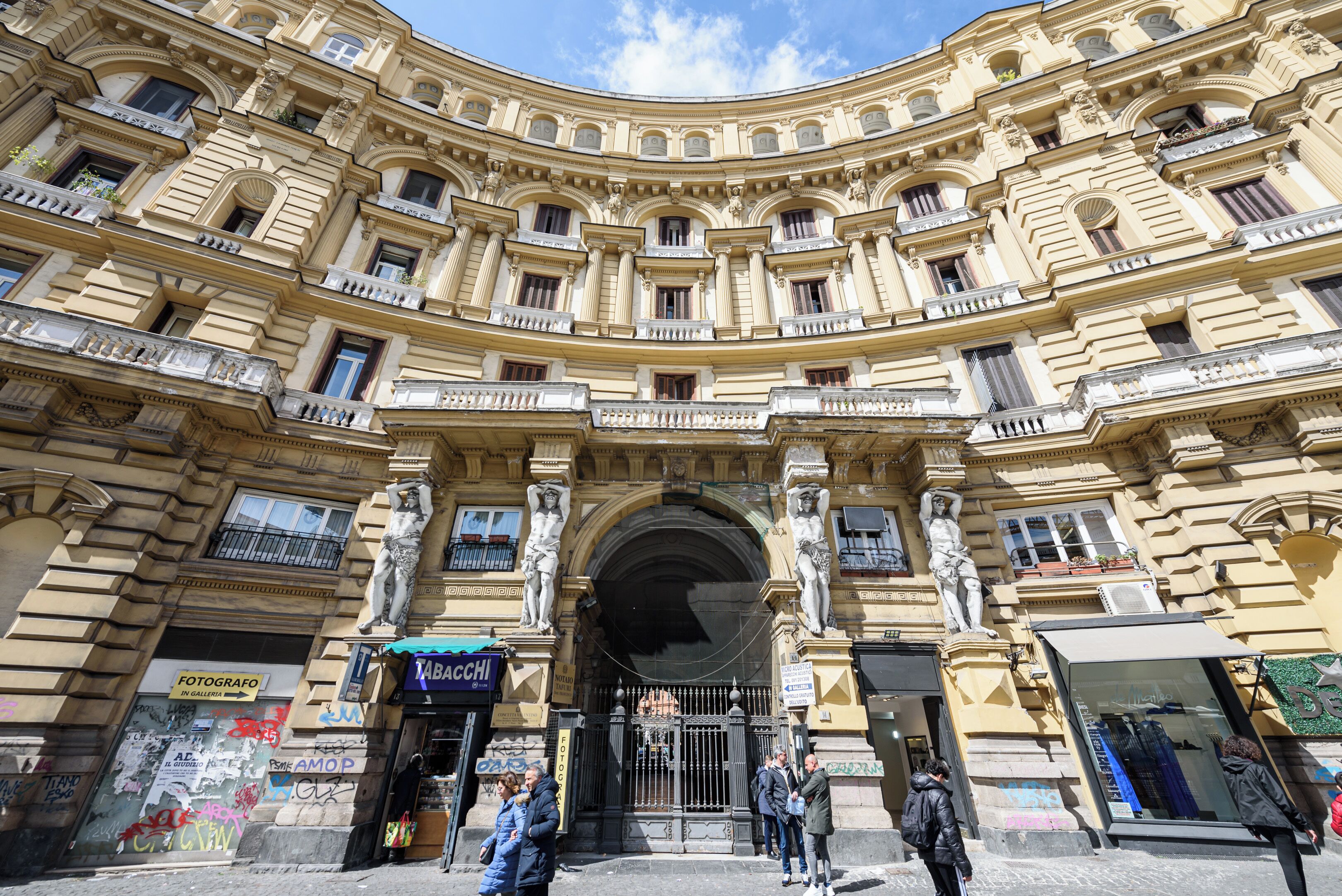 A historic building with ornate architecture, multiple balconies, and a central entrance.