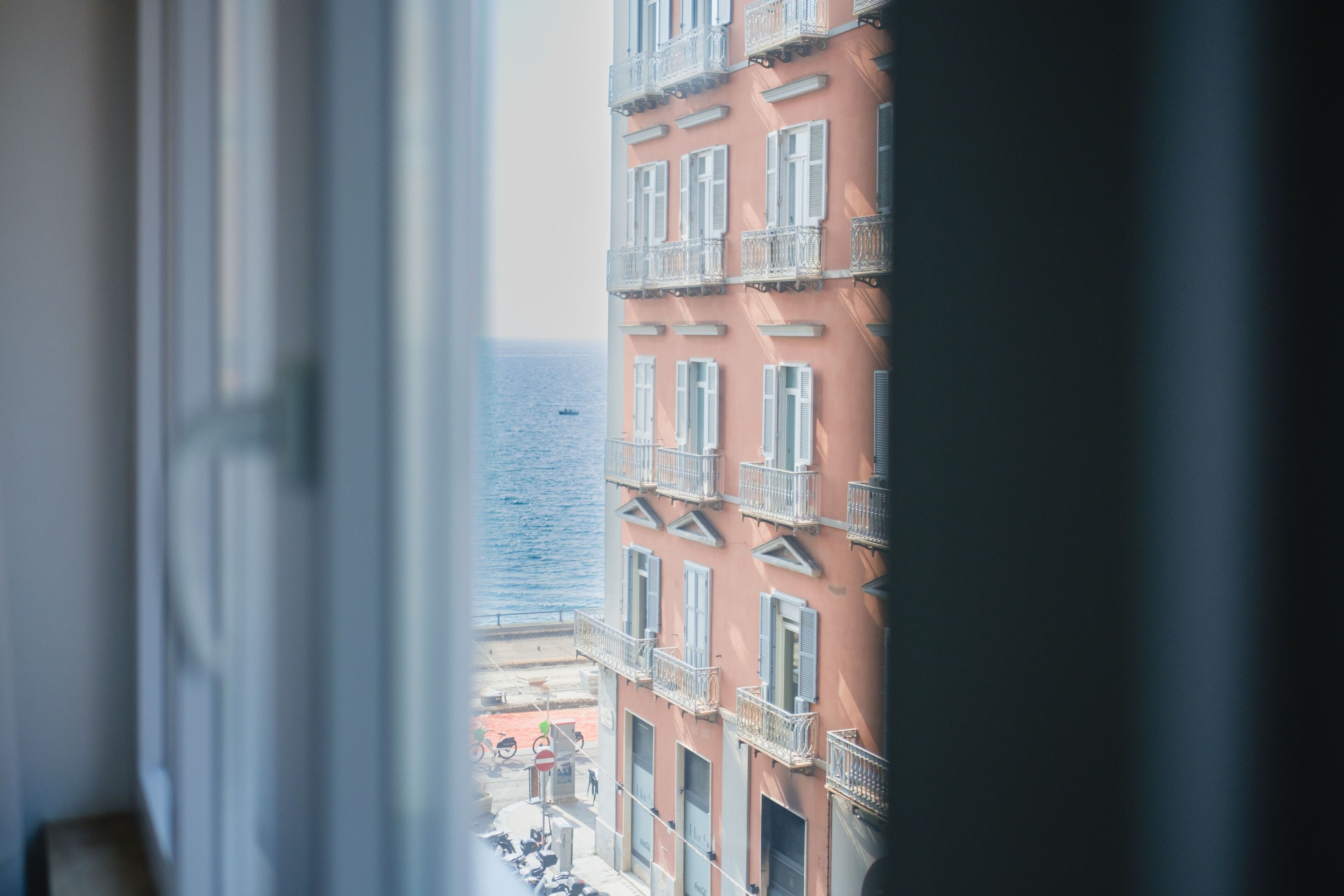 A building with balconies and a view of the sea.