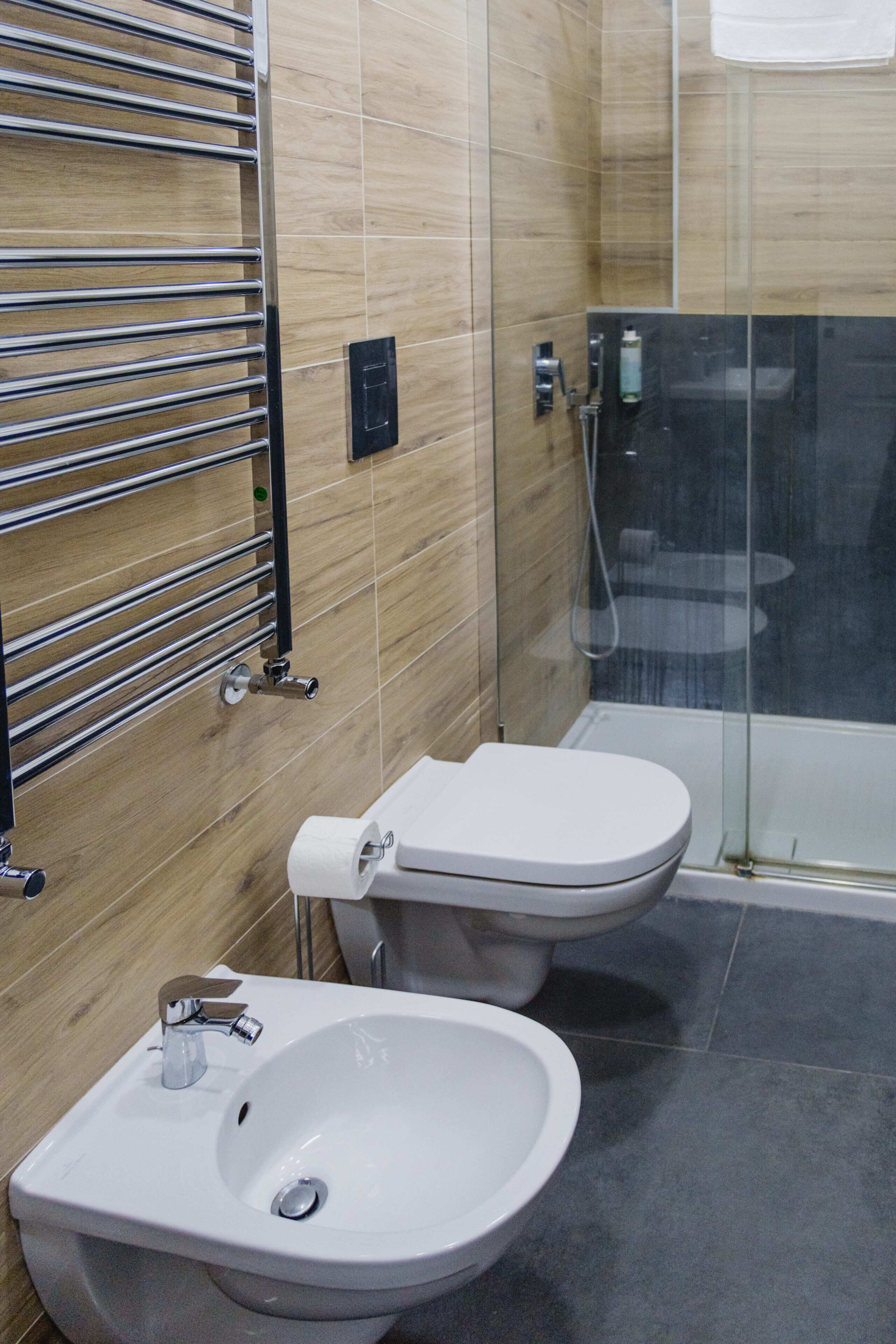 A modern bathroom with a toilet, bidet, and sink.