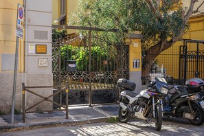 A gated entrance with a motorcycle parked in front. - Via Aniello Falcone 72b (Naples)