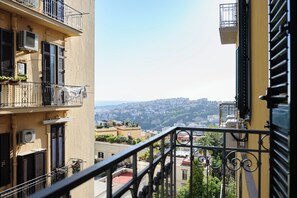 Ein Balkon mit Blick auf eine dicht bebauete Stadtlandschaft.