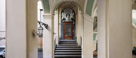 A staircase leading to a door with a decorative archway.