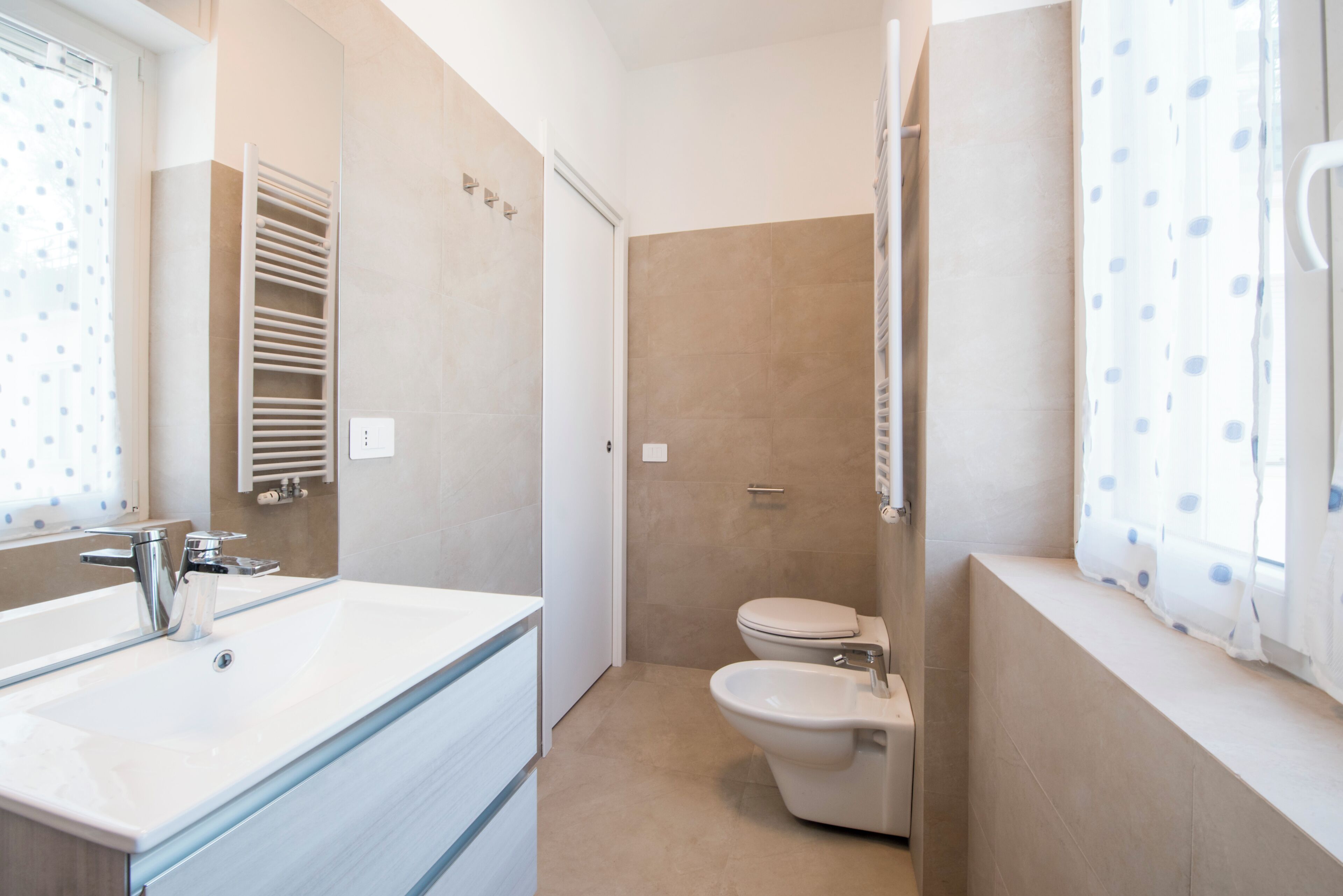 A bathroom with a sink, toilet, and shower.