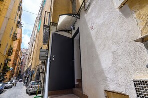 A narrow street with parked cars and buildings on both sides. - A Tazzulella - Vico Graziella 12 (Naples)