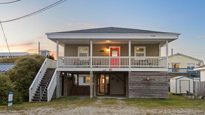 A two-story house with a front porch, a staircase, and a garage. - Close to beach, pier and restaurants (Surf City)
