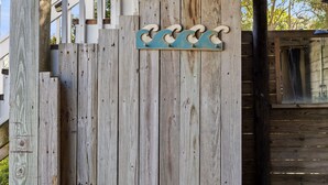 A wooden fence with a decorative metal wave pattern. - Close to beach, pier and restaurants (Surf City)