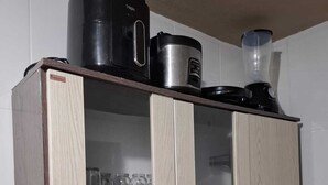 Eine Küche mit Einbauküche, einer Kaffeemaschine, einem Mixer und einem Wasserkocher.