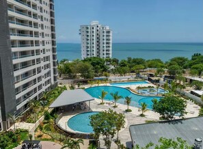 A hotel with multiple swimming pools, a covered seating area, and a view of the ocean. - Luxury studio in Santa Marta | Ocean View (Santa Marta)
