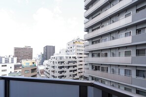 A multi-story residential building with balconies, large windows, and a modern architectural style. - MFPR Court Nipponbashi East (Osaka)