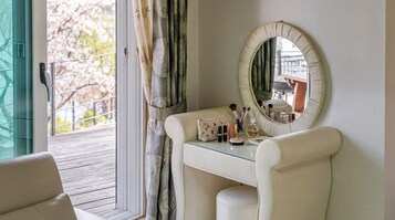 A bathroom with a vanity, a mirror, and toiletries.