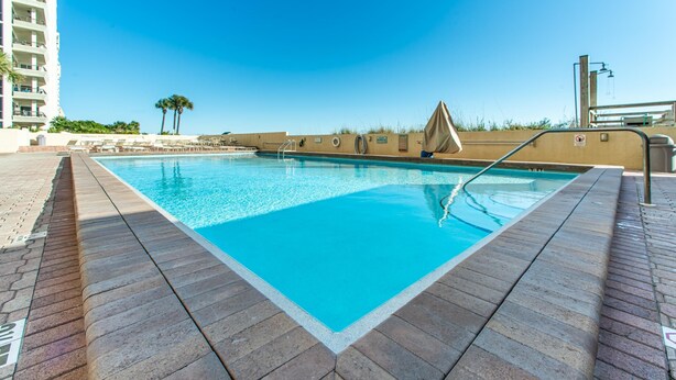 A rectangular swimming pool with a clear blue water surface, surrounded by a tiled deck. - Sundestin 105 (Destin)