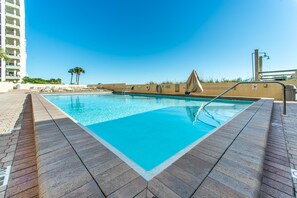 A rectangular swimming pool with a clear blue water surface, surrounded by a tiled deck. - Sundestin 105 (Destin)