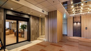 A modern lobby with a Tamamo Lounge entrance, a wooden panel wall, and a tiled floor. - JR Clement Inn Takamatsu Hyogomachi (Takamatsu)
