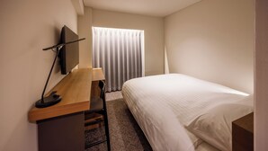 A hotel room with a bed, a desk with a chair, a television, and a window with curtains. - JR Clement Inn Takamatsu Hyogomachi (Takamatsu)