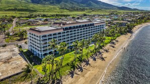 A hotel with a multi-story structure, a beachside location, and a mountainous backdrop. - SUMMER SALE! Remodeled Wonderful West Maui Mountain View in Oceanfront Resort - Lahaina Shores 620 (Lahaina)